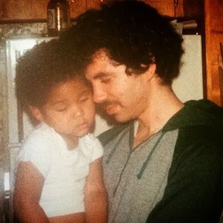 Joel Smollett during his youth with young Jussie Smollett in his arms. 